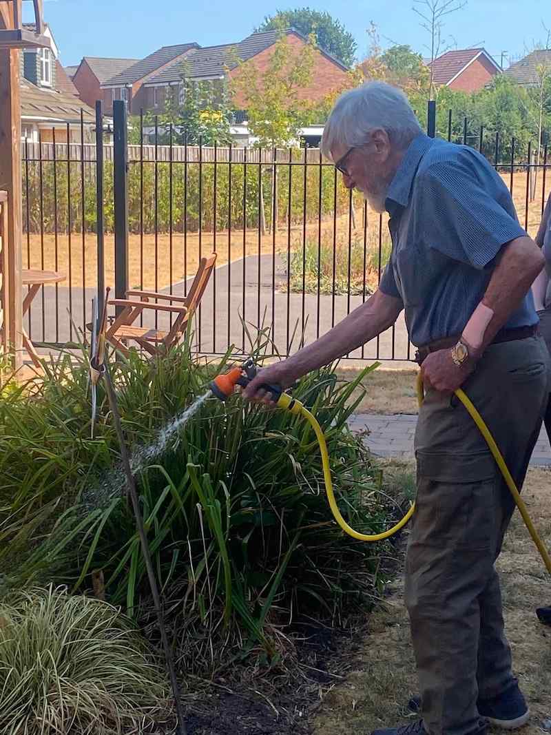 one of our residents watering the plants