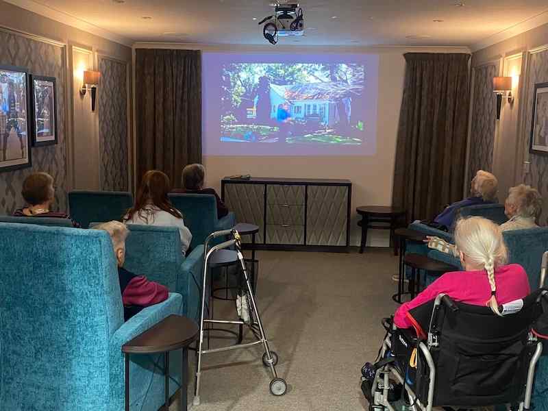 a group of residents sat in our cinema room enjoying a film