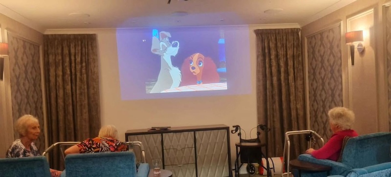 a group of residents sat in our cinema room enjoying lady and the tramp