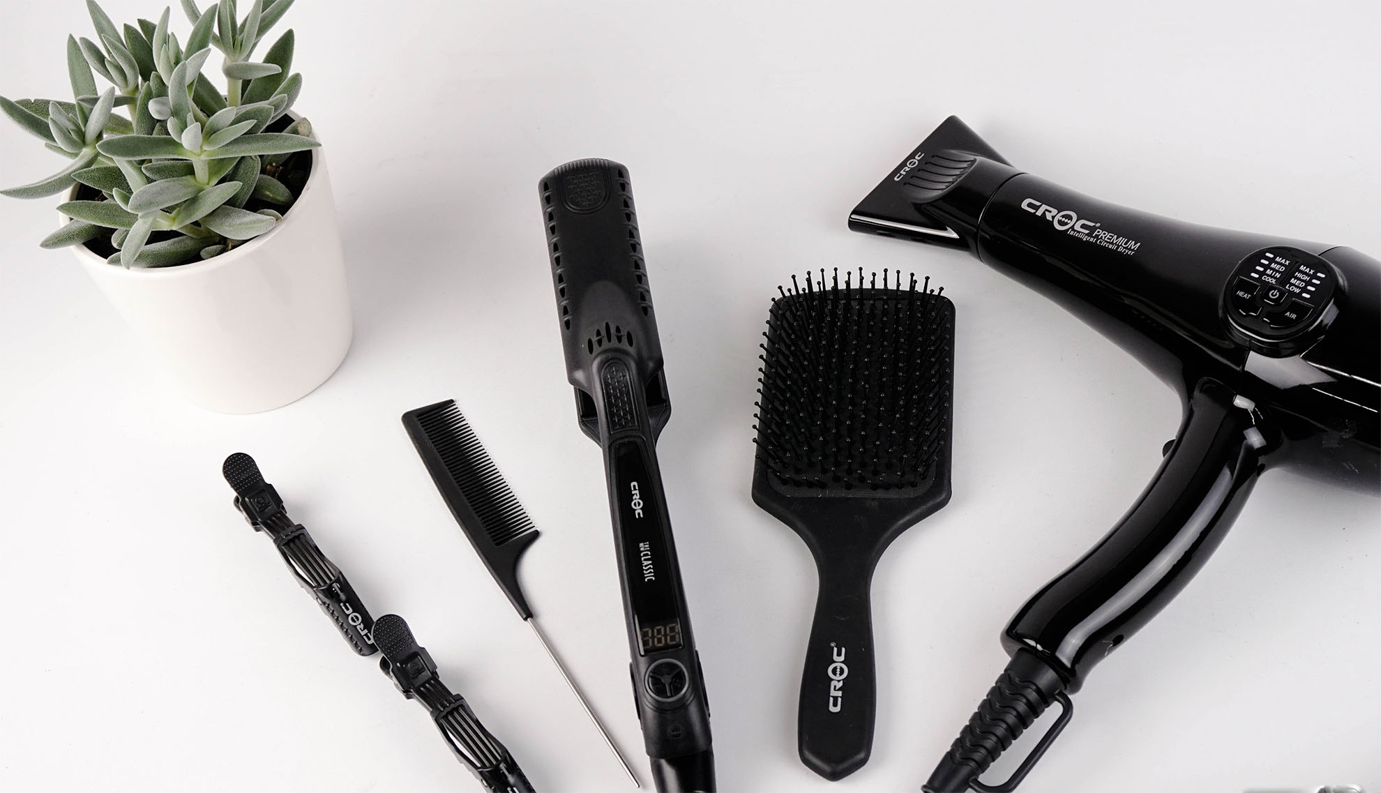 hairdressing tools including straightener, brush, hairdryer, comb and clips