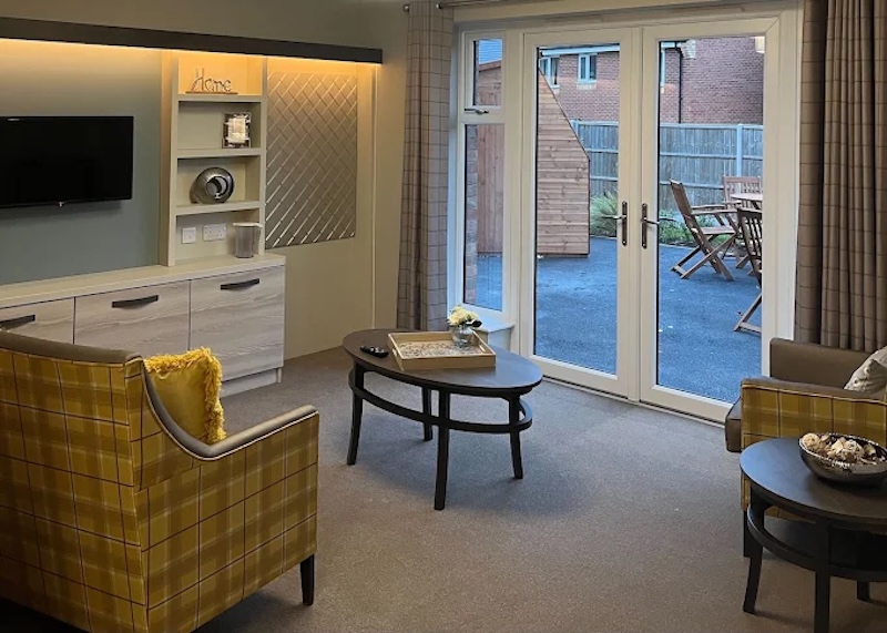 one of our lounges with comfortable yellow armchairs and a round table in the middle