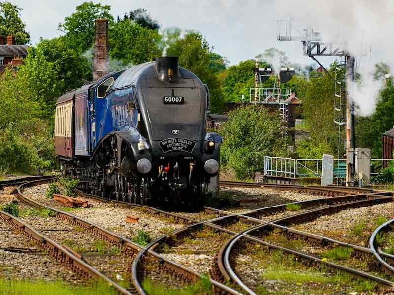 an old fashioned train on railway tracks in shrewsbury